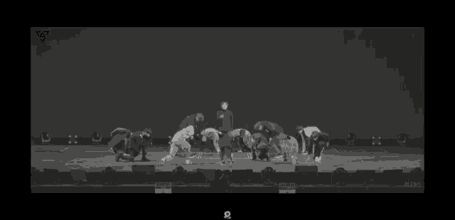 a group of people are standing on top of each other on a stage .