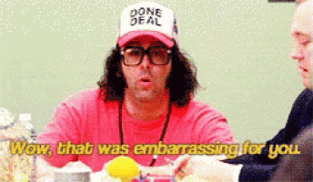 a man wearing glasses and a hat that says done deal