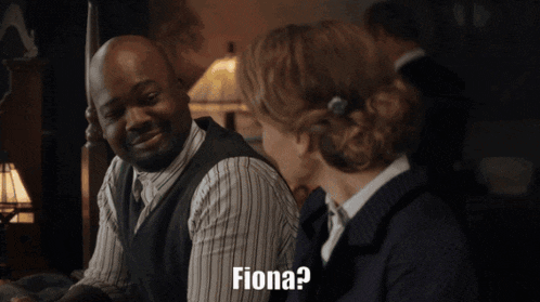 a man and a woman are sitting next to each other and the woman is asking the man if he is fiona