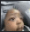 a blurry picture of a person 's face while sitting in a chair .