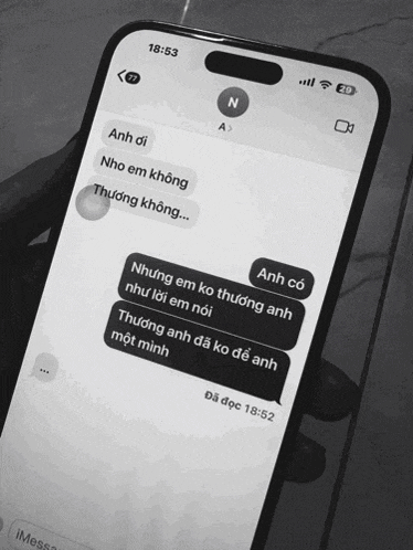 a black and white photo of a phone that says 18:53 on the screen