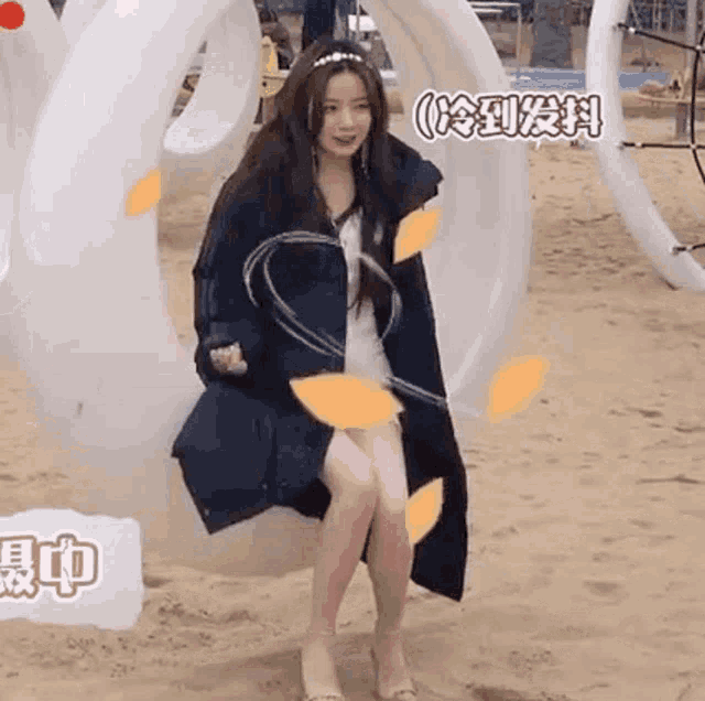 a woman is sitting on a swing with a hula hoop around her waist .