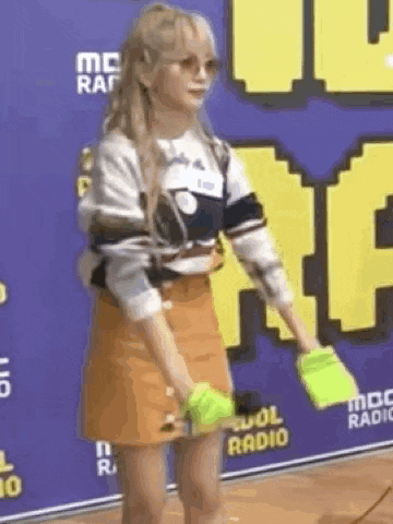 a girl is standing in front of a sign that says radio .