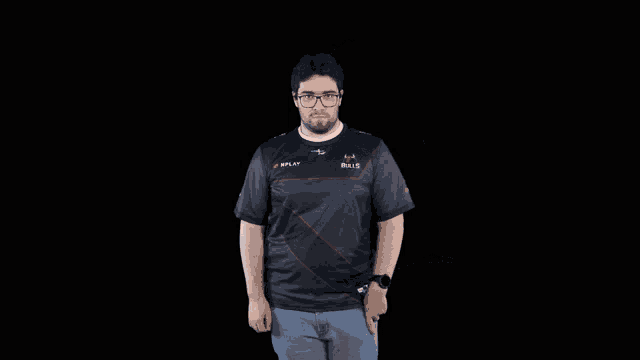 a man wearing a nplay shirt is dancing