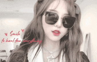 a woman wearing sunglasses and a star necklace with the words smile to hear the everywhere