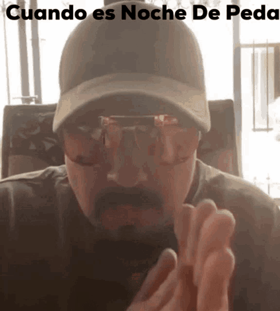 a man wearing sunglasses and a hat with the words cuando es noche de peda above him