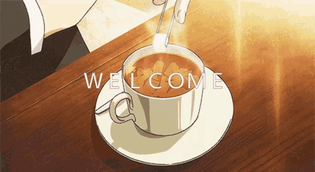 a cup of coffee sits on a saucer with the word welcome written on it