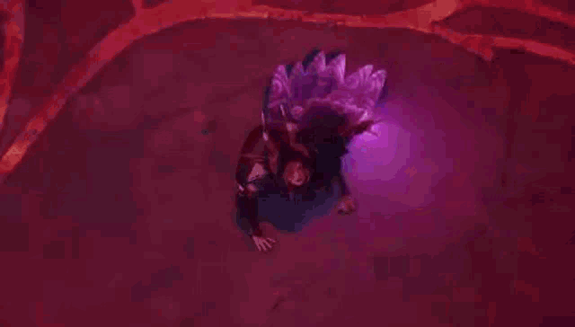 a person is flying through a purple lightning storm in a dark room .