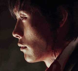a close up of a man 's face with blood coming out of his neck