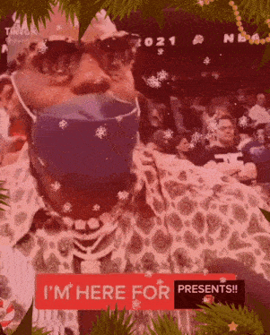 a man wearing a face mask and sunglasses is standing in front of a crowd of people .