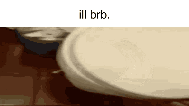 a close up of a paper plate on a table with the words `` ill brb '' written on the bottom .