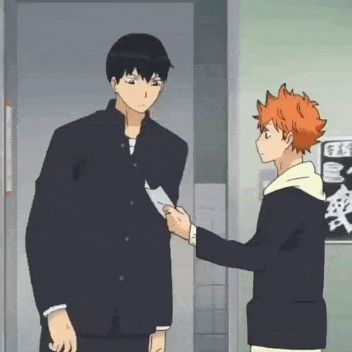 two anime characters are standing next to each other and one is holding a piece of paper in his hand