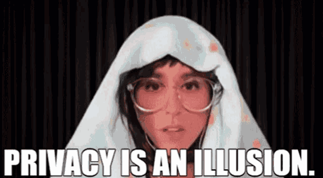 a woman with glasses and a blanket on her head is talking about privacy .