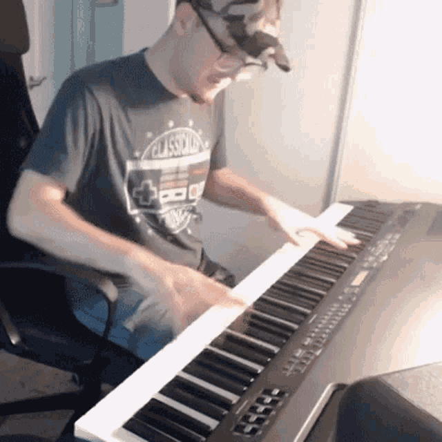 a man is playing a keyboard with a classical shirt on