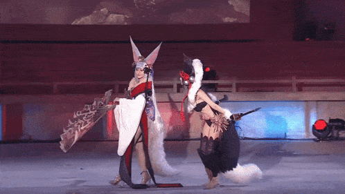 a woman in a fox costume holds a fan while another woman holds a sword