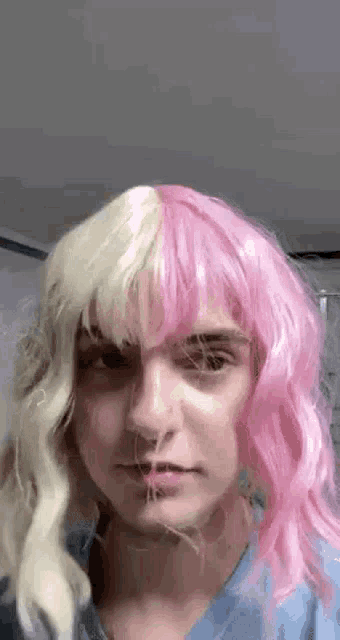a person wearing a pink wig and a white wig .
