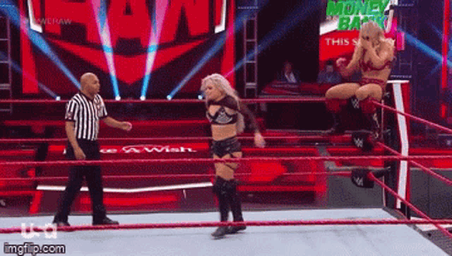 two women are wrestling in a ring with a referee in the background
