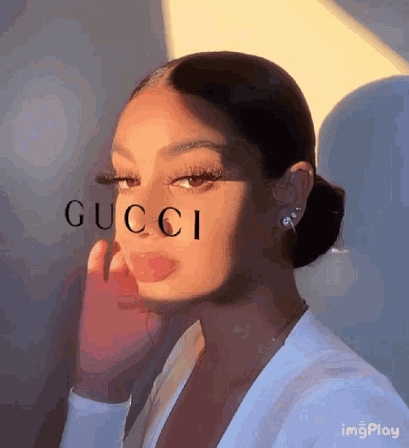 a close up of a woman 's face with gucci written on her face