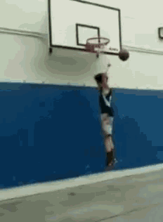a person is jumping in the air with a basketball in their hand