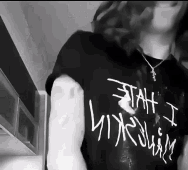 a black and white photo of a person wearing a t-shirt that says " stay i like you " on it
