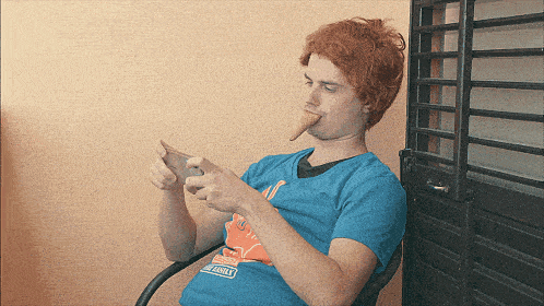a man eating an ice cream cone while wearing a t-shirt that says ' simpson ' on it
