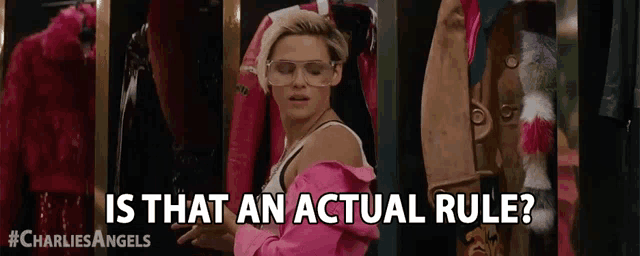 a woman wearing glasses and a pink jacket is standing in a closet and asking is that an actual rule ?