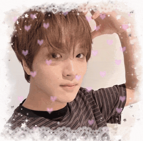 a close up of a young man 's face with hearts and stars around him