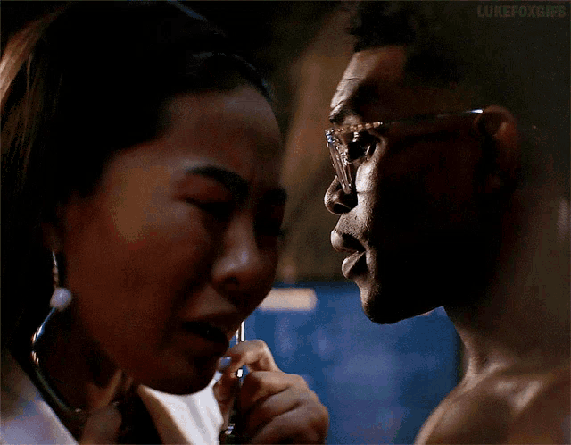 a man and a woman are looking at each other and the caption lukefoxgifs