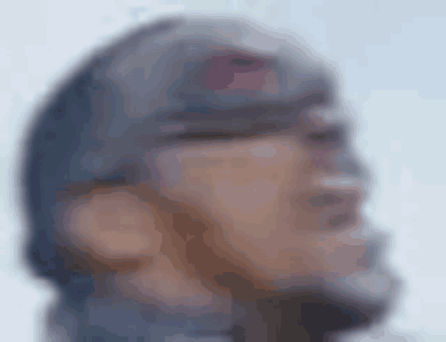 a blurry picture of a man wearing a hat
