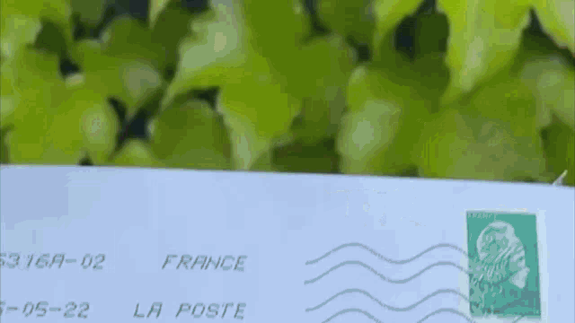 an envelope from france with a green stamp on it