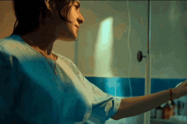 a woman in a hospital gown with a drip on her arm