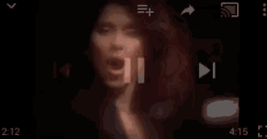 a close up of a woman 's face in a dark room .