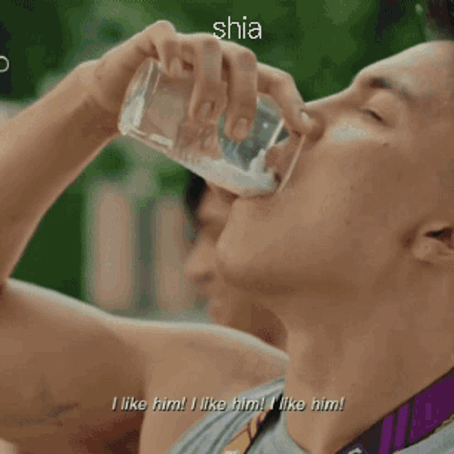 a young man is eating something with the word shia written above him