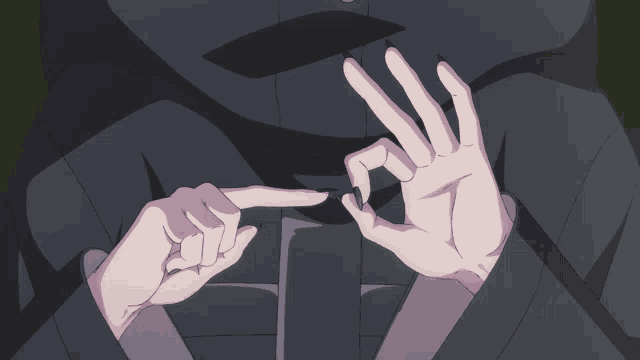 a close up of a person 's hands making a thumbs up sign