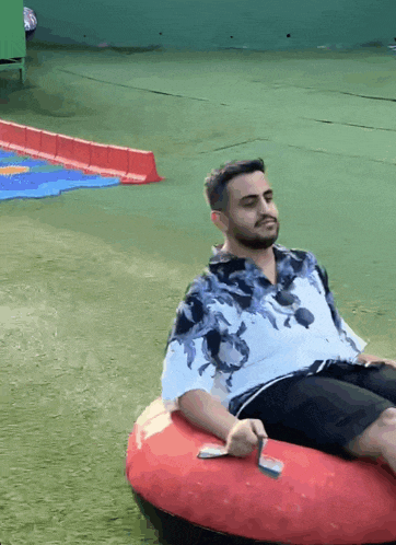 a man with a beard is sitting on an inflatable raft .