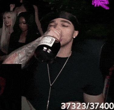 a man is holding a bottle of wine with the number 3732237400 on the bottom