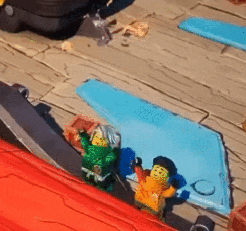 a couple of lego figures sitting on top of a blue mat on a wooden floor .