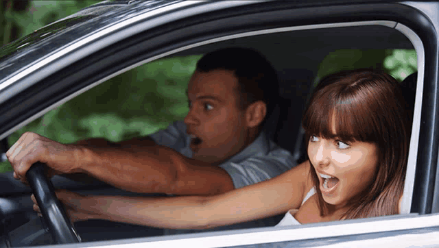 a man and a woman are sitting in a car