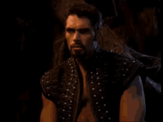 a man with a beard and a black vest says are you two insane