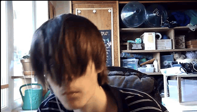 a person 's head is visible in front of a blackboard that says out