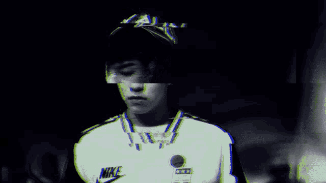 a man wearing a nike shirt with a sticker on it
