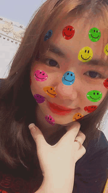 a woman with smiley faces on her face