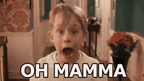 a young boy is making a funny face and saying oh mamma .