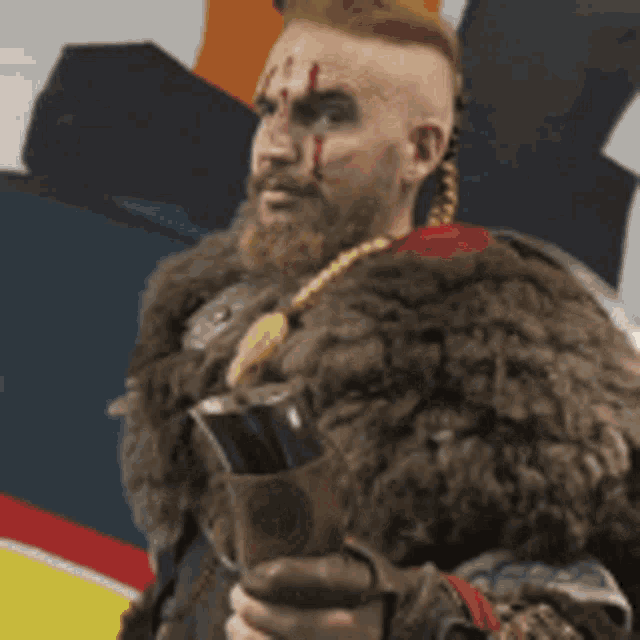 a man with a beard and a fur coat is holding a sword .