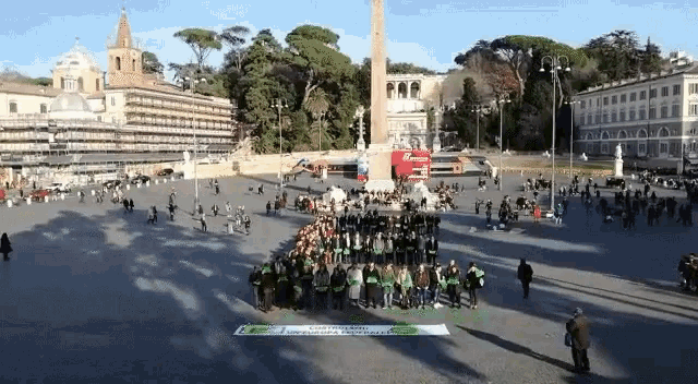 a large group of people are gathered in a square with a sign that says " giornata mondiale della salute " on it