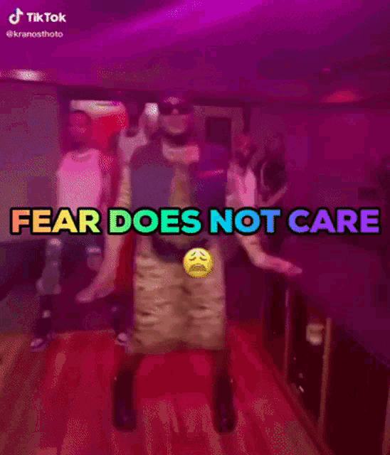 a man is dancing with the words fear does not care