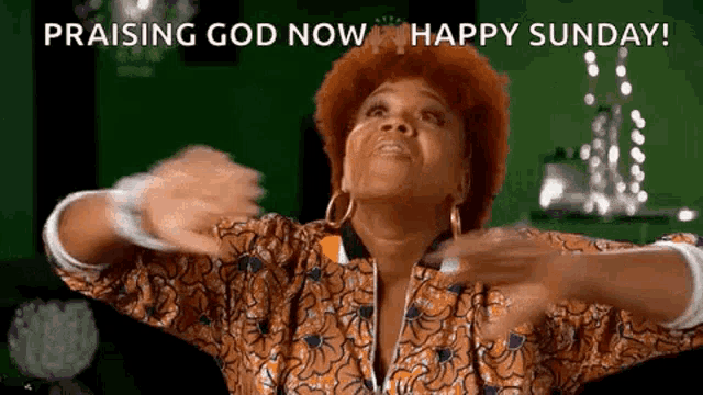 a woman with red hair is praising god now happy sunday .