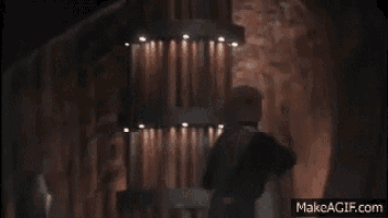 a man is holding a rope in a dark room with lights on the walls .