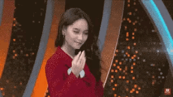 a pixelated image of a woman in a red jacket