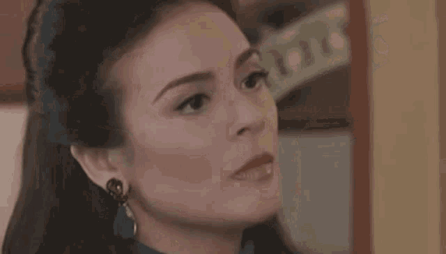 a woman is looking at herself in the mirror and making a funny face .